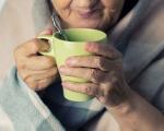 Older person with a hot drink