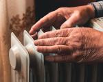 older person's hands on a radiator