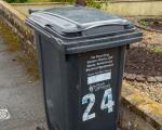 A black waste bin